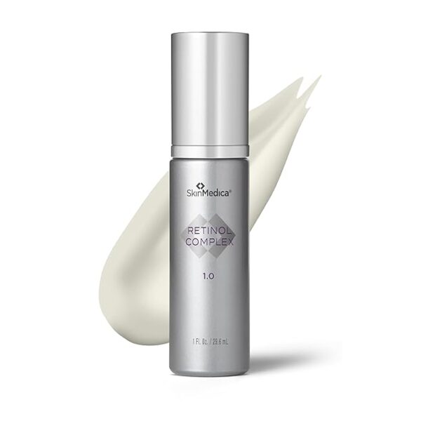 SkinMedica Retinol 1.0 Complex serum bottle, silver pump dispenser with a cream swatch behind it.